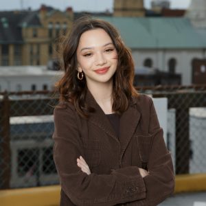 Rachel Ainsworth poses for photo with cityscape in the background.