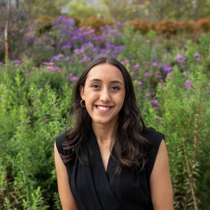 Shailaja Gillett poses for photo with wildflowers in the background.