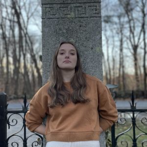 Elly Hume poses for photo in front of a monument.