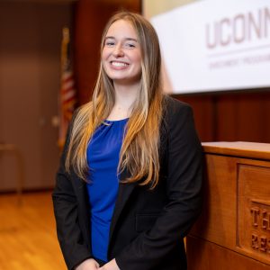 Olivia Joyce poses for photo in UConn lecture hall.