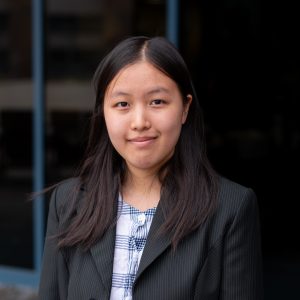 Lucy Liu poses for a photo with a building in the background.