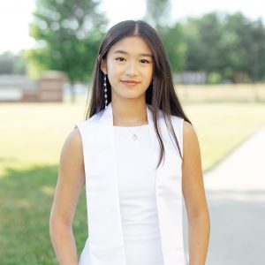 Shen Wan poses for photo outdoors.